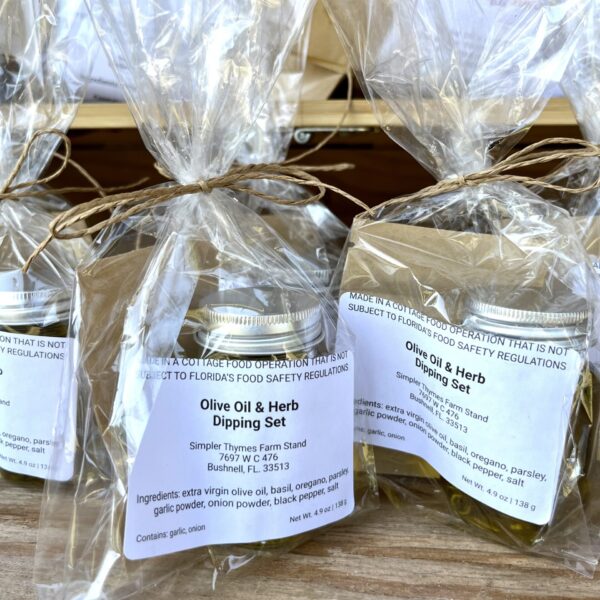 2 oz bottle of extra virgin olive oil and a small envelope of herbs